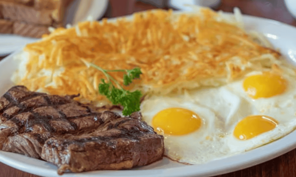 Hearty breakfast platter with eggs any style, bacon, potatoes, and toast